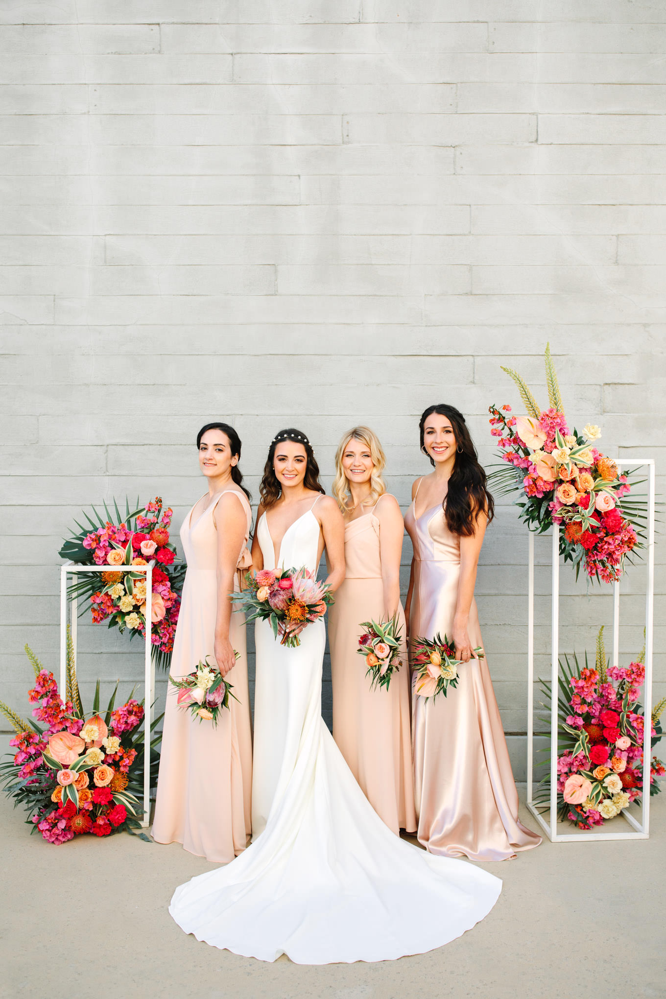 Bridesmaids with tropical floral installations at Malibu micro wedding | Engagement, elopement, and wedding photography roundup of Mary Costa’s favorite images from 2020 | Colorful and elevated photography for fun-loving couples in Southern California | #2020wedding #elopement #weddingphoto #weddingphotography #microwedding   Source: Mary Costa Photography | Los Angeles