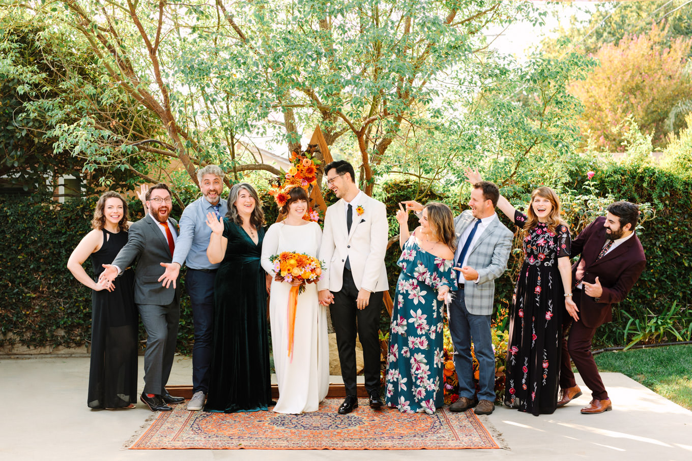 Guests at backyard autumn micro wedding with colorful triangle arch | Engagement, elopement, and wedding photography roundup of Mary Costa’s favorite images from 2020 | Colorful and elevated photography for fun-loving couples in Southern California | #2020wedding #elopement #weddingphoto #weddingphotography #microwedding   Source: Mary Costa Photography | Los Angeles