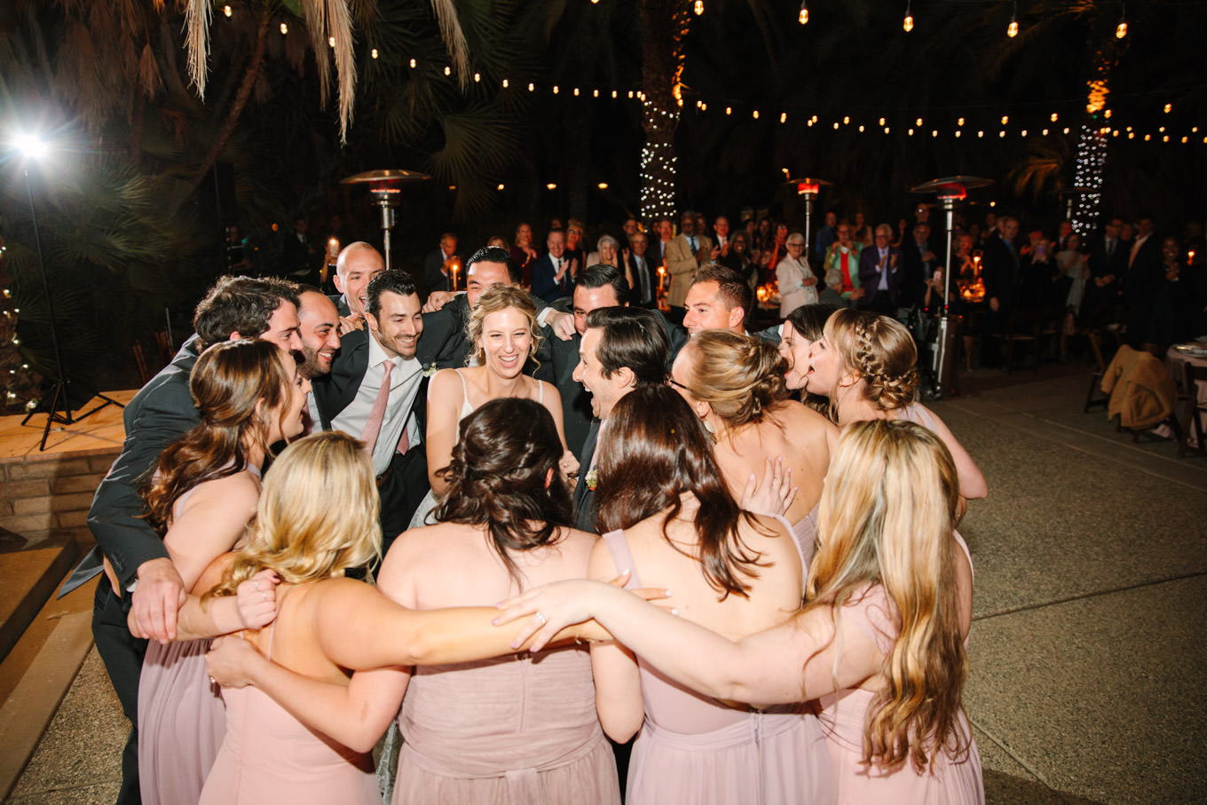 Wedding party group hug | Living Desert Zoo & Gardens wedding with unique details | Elevated and colorful wedding photography for fun-loving couples in Southern California |  #PalmSprings #palmspringsphotographer #gardenwedding #palmspringswedding  Source: Mary Costa Photography | Los Angeles wedding photographer 