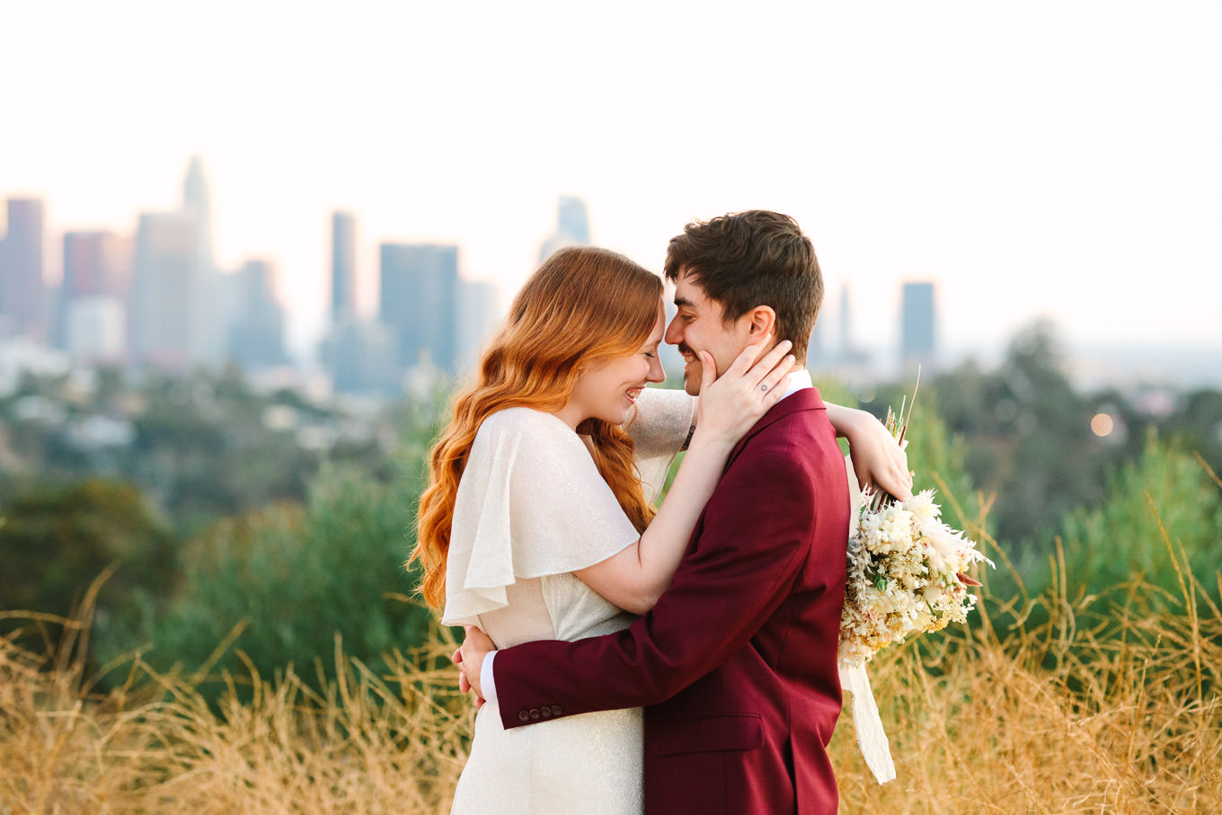 Elopement portrait with LA skyline | Los Angeles Elysian Park Elopement | Colorful and elevated wedding photography for fun-loving couples in Southern California | #LosAngelesElopement #elopement #LAarboretum #LAskyline #elopementphotos   Source: Mary Costa Photography | Los Angeles