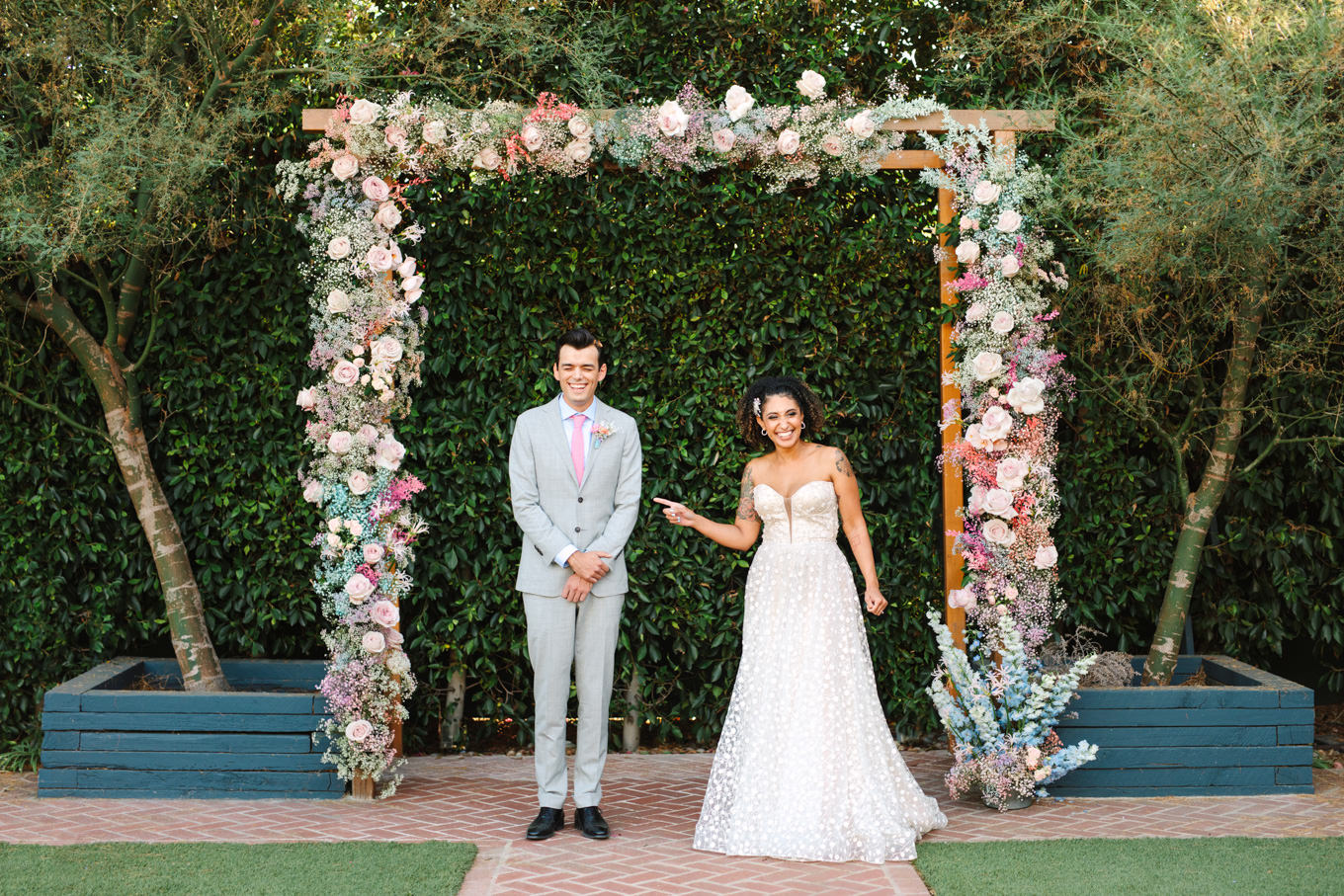 Cute first look with bride and groom | Colorful pop-up micro wedding at The Ruby Street Los Angeles featured on Green Wedding Shoes | Colorful and elevated photography for fun-loving couples in Southern California | #colorfulwedding #popupwedding #weddingphotography #microwedding Source: Mary Costa Photography | Los Angeles
