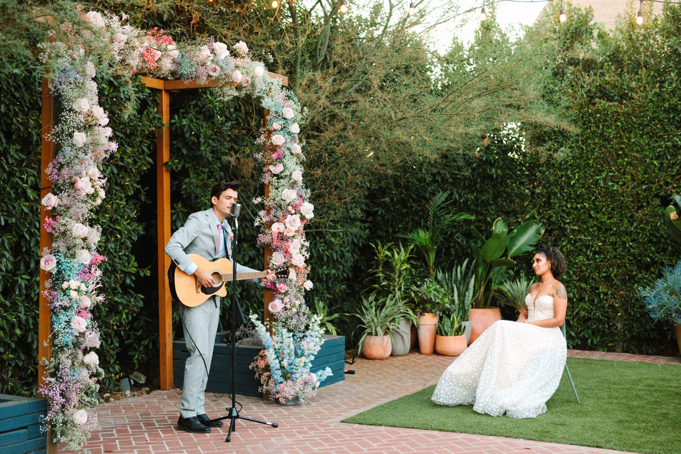 Groom serenading the bride | Colorful pop-up micro wedding at The Ruby Street Los Angeles featured on Green Wedding Shoes | Colorful and elevated photography for fun-loving couples in Southern California | #colorfulwedding #popupwedding #weddingphotography #microwedding Source: Mary Costa Photography | Los Angeles