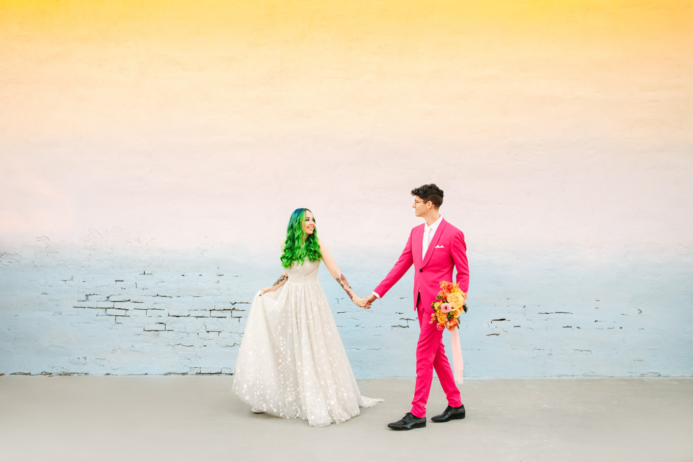 Groom in hot pink suit with bride in star gown with green hair | Colorful wedding at The Unique Space Los Angeles published in The Knot Magazine | Fresh and colorful photography for fun-loving couples in Southern California | #colorfulwedding #losangeleswedding #weddingphotography #uniquespace Source: Mary Costa Photography | Los Angeles