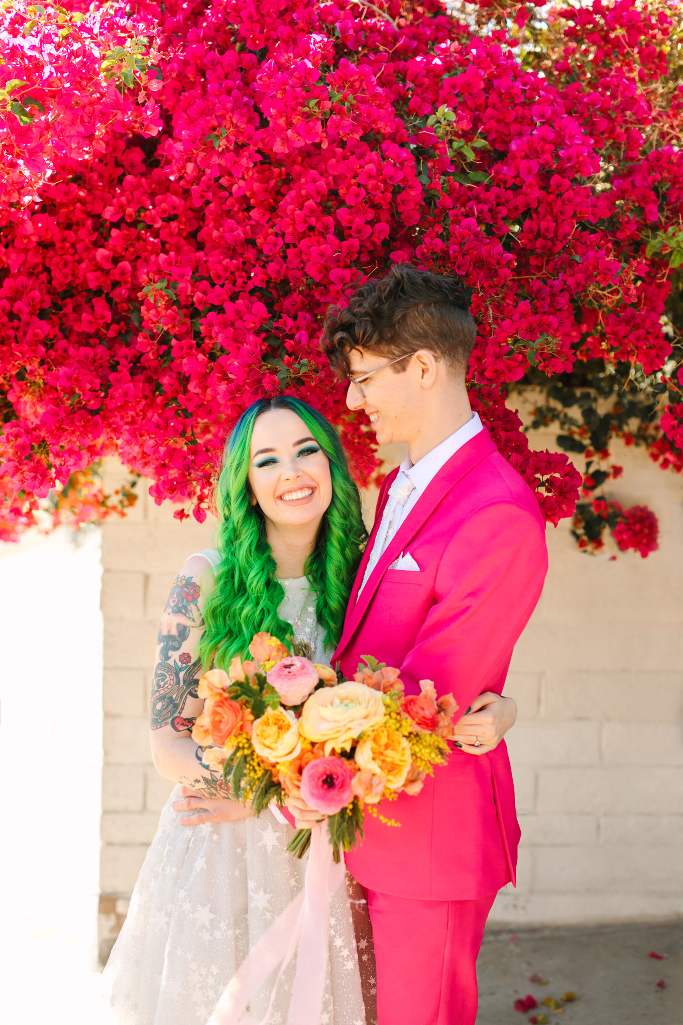 Colorful bride and groom in front of blooming bougainvillea | Colorful wedding at The Unique Space Los Angeles published in The Knot Magazine | Fresh and colorful photography for fun-loving couples in Southern California | #colorfulwedding #losangeleswedding #weddingphotography #uniquespace Source: Mary Costa Photography | Los Angeles