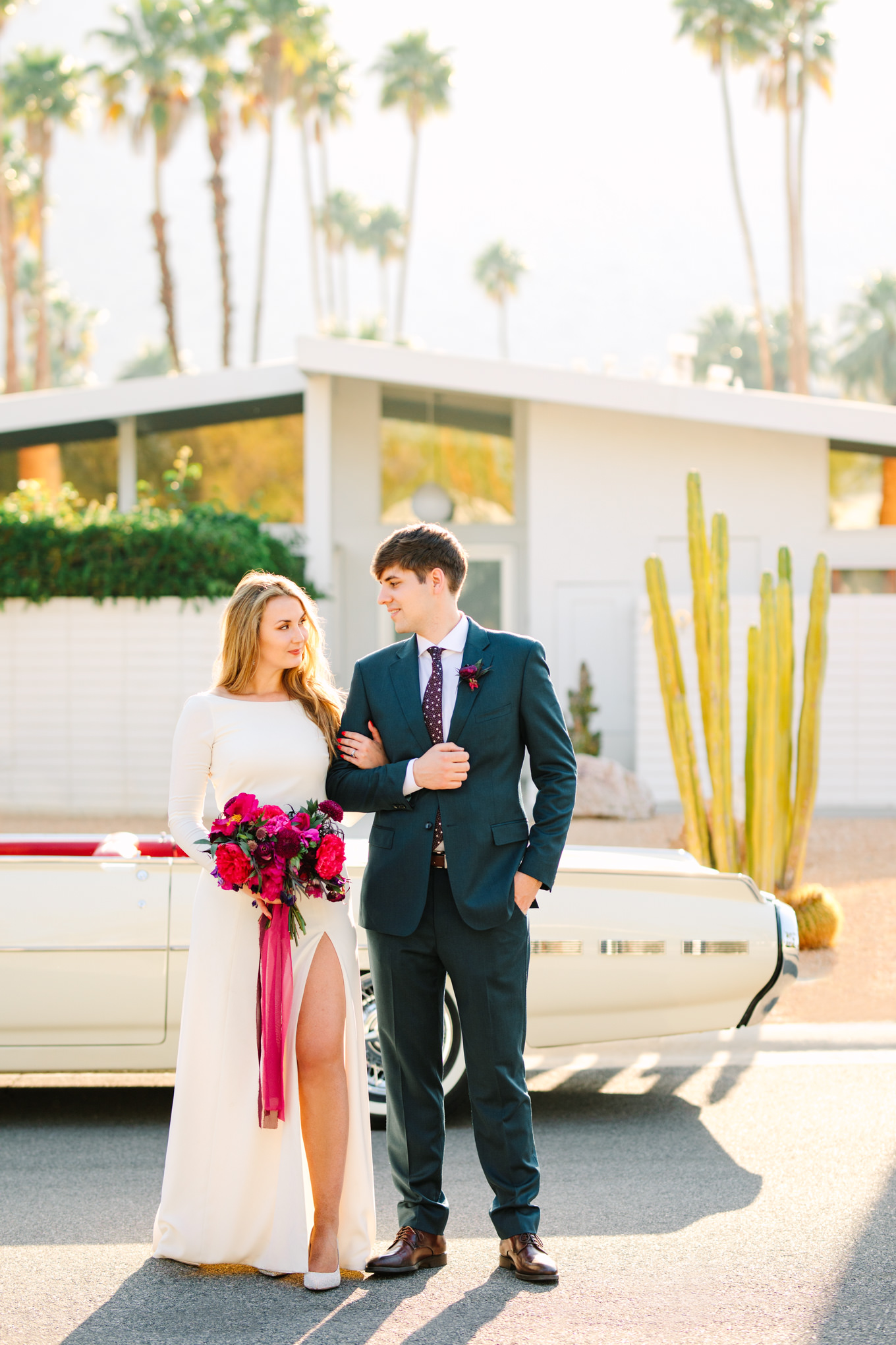 Bride and groom with classic car | Colorful jewel tone Palm Springs elopement | Fresh and colorful photography for fun-loving couples in Southern California | #colorfulelopement #palmspringselopement #elopementphotography #palmspringswedding Source: Mary Costa Photography | Los Angeles