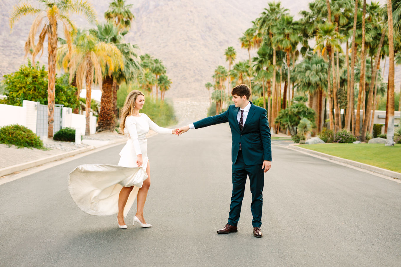 Bride and groom walking in the street | Colorful jewel tone Palm Springs elopement | Fresh and colorful photography for fun-loving couples in Southern California | #colorfulelopement #palmspringselopement #elopementphotography #palmspringswedding Source: Mary Costa Photography | Los Angeles