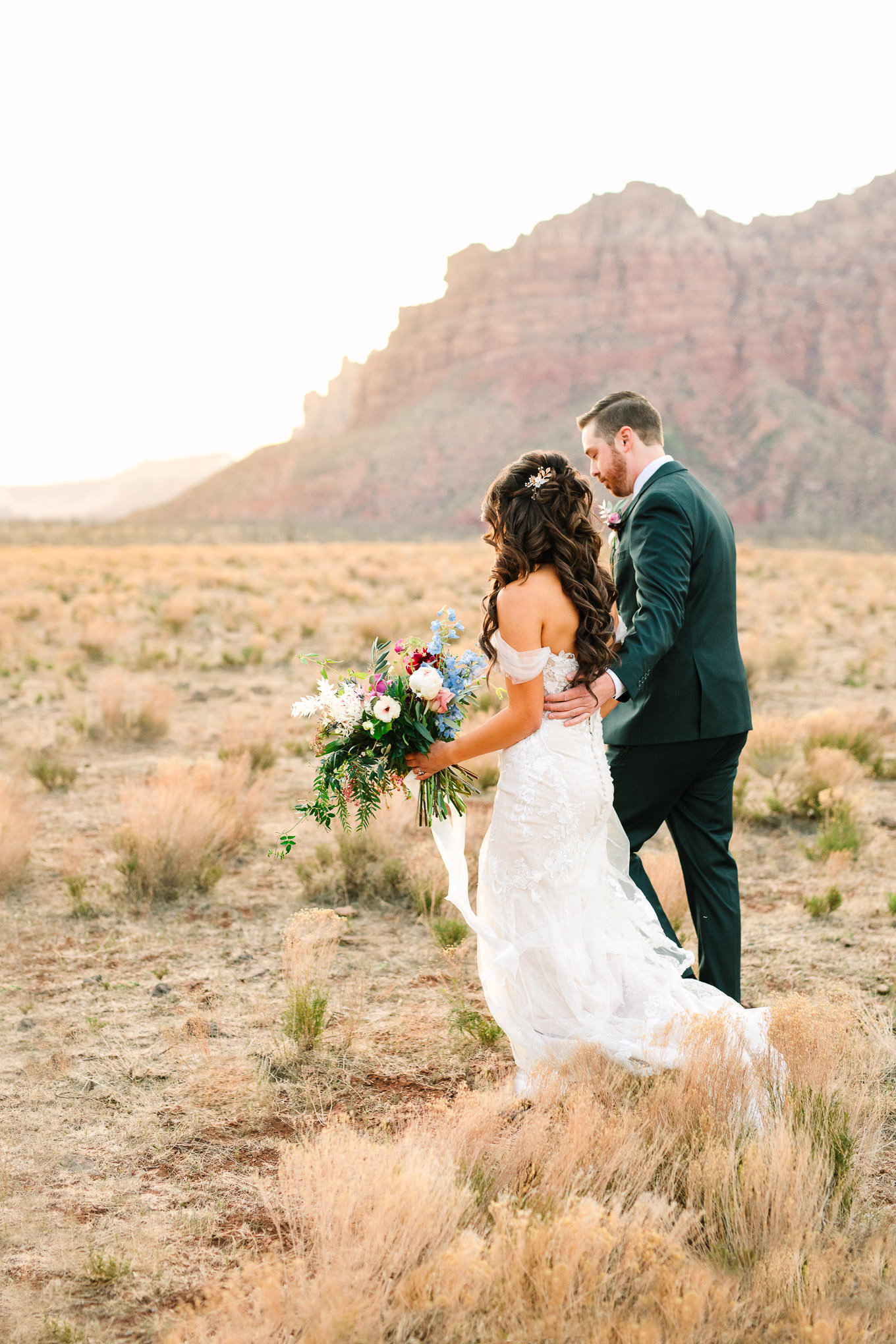 Bride and groom walking to ceremony | Zion Under Canvas camping elopement at sunrise | Colorful elopement photography | #utahelopement #zionelopement #zionwedding #undercanvaszion #sunriseelopement #adventureelopement  Source: Mary Costa Photography | Los Angeles