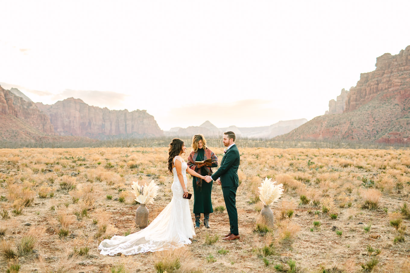 Ceremony among mountains | Zion Under Canvas camping elopement at sunrise | Colorful elopement photography | #utahelopement #zionelopement #zionwedding #undercanvaszion #sunriseelopement #adventureelopement  Source: Mary Costa Photography | Los Angeles