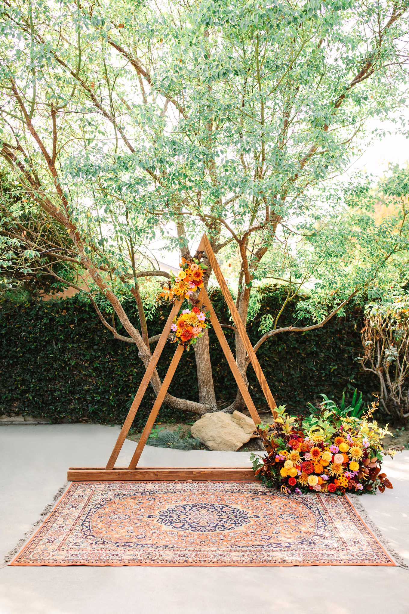 Fun and unique ceremony arch with florals | Vibrant backyard micro wedding featured on Green Wedding Shoes | Colorful LA wedding photography | #losangeleswedding #backyardwedding #microwedding #laweddingphotographer Source: Mary Costa Photography | Los Angeles