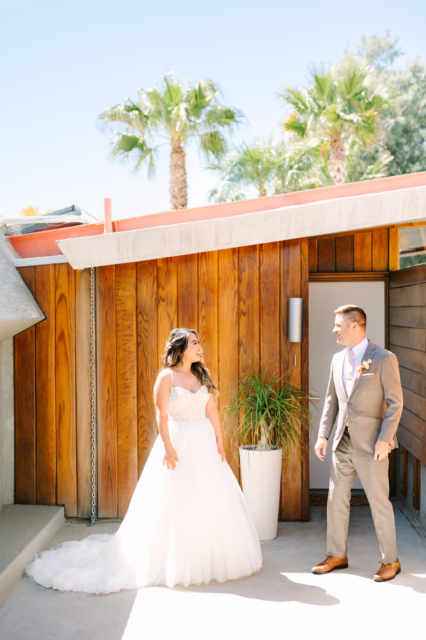 First look with bride and groom | Pink and orange Lautner Compound wedding | Colorful Palm Springs wedding photography | #palmspringsphotographer #palmspringswedding #lautnercompound #southerncaliforniawedding  Source: Mary Costa Photography | Los Angeles