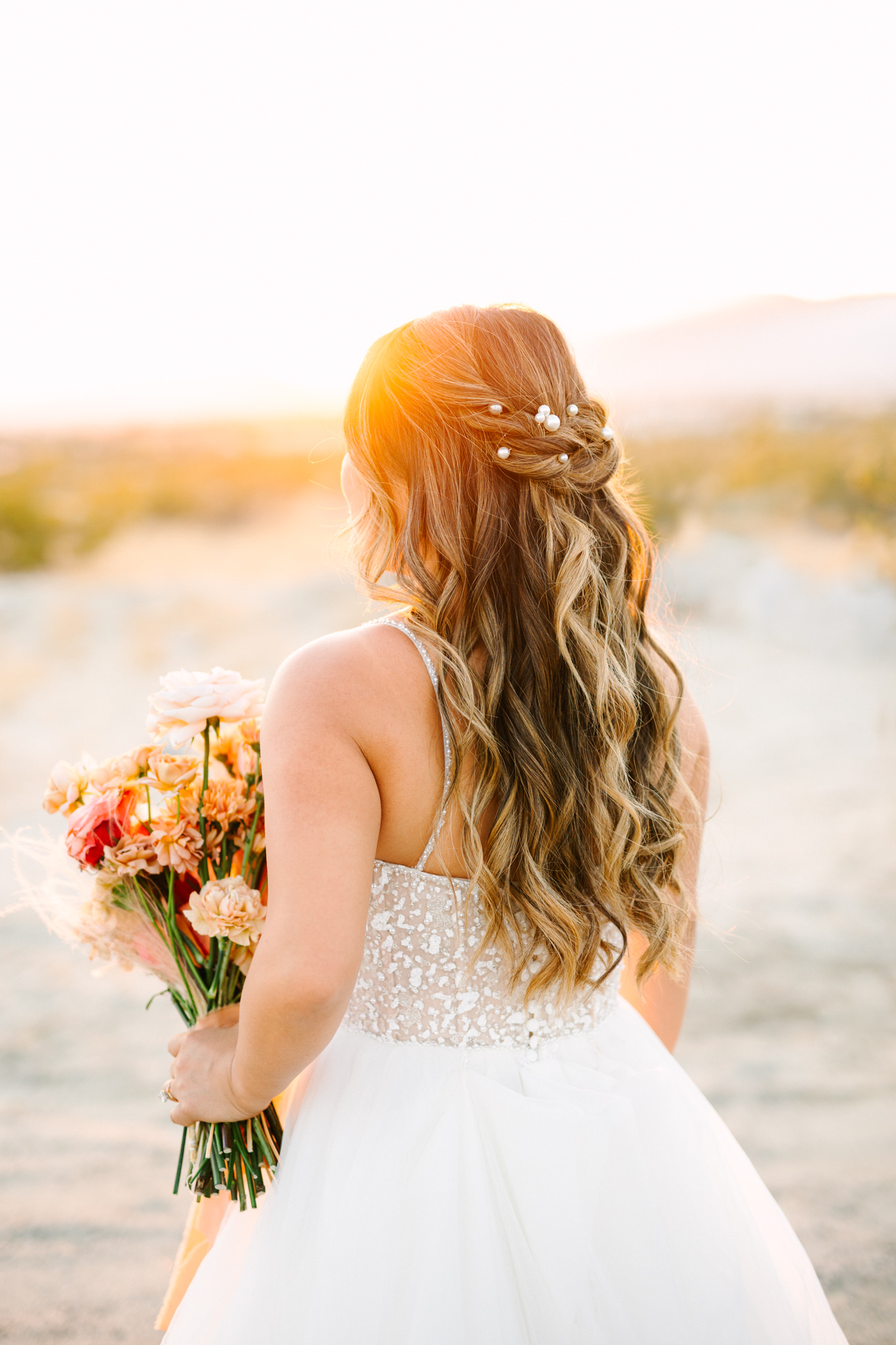 Bridal half updo with pearls | Pink and orange Lautner Compound wedding | Colorful Palm Springs wedding photography | #palmspringsphotographer #palmspringswedding #lautnercompound #southerncaliforniawedding  Source: Mary Costa Photography | Los Angeles
