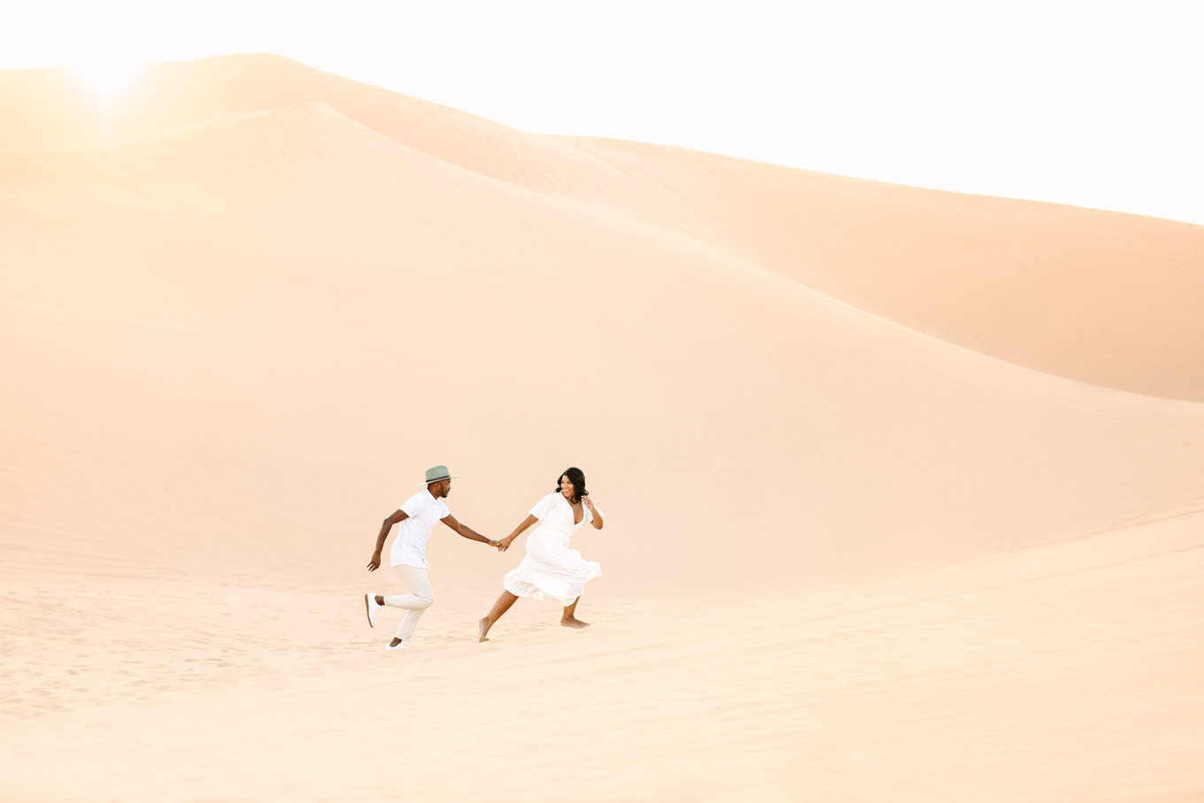 Couple running in the sand dunes | | California Sand Dunes engagement session | Colorful Palm Springs wedding photography | #palmspringsphotographer #sanddunes #engagementsession #southerncalifornia  Source: Mary Costa Photography | Los Angeles