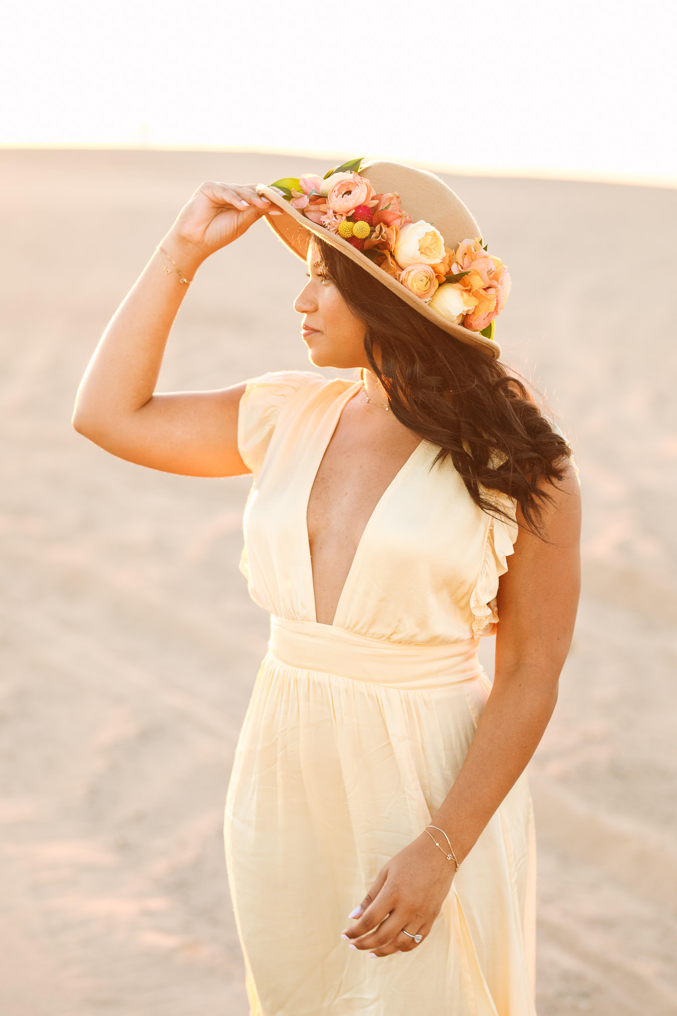 Portrait of a bride to be wearing sunhat with flowers | California Sand Dunes engagement session | Colorful Palm Springs wedding photography | #palmspringsphotographer #sanddunes #engagementsession #southerncalifornia  Source: Mary Costa Photography | Los Angeles