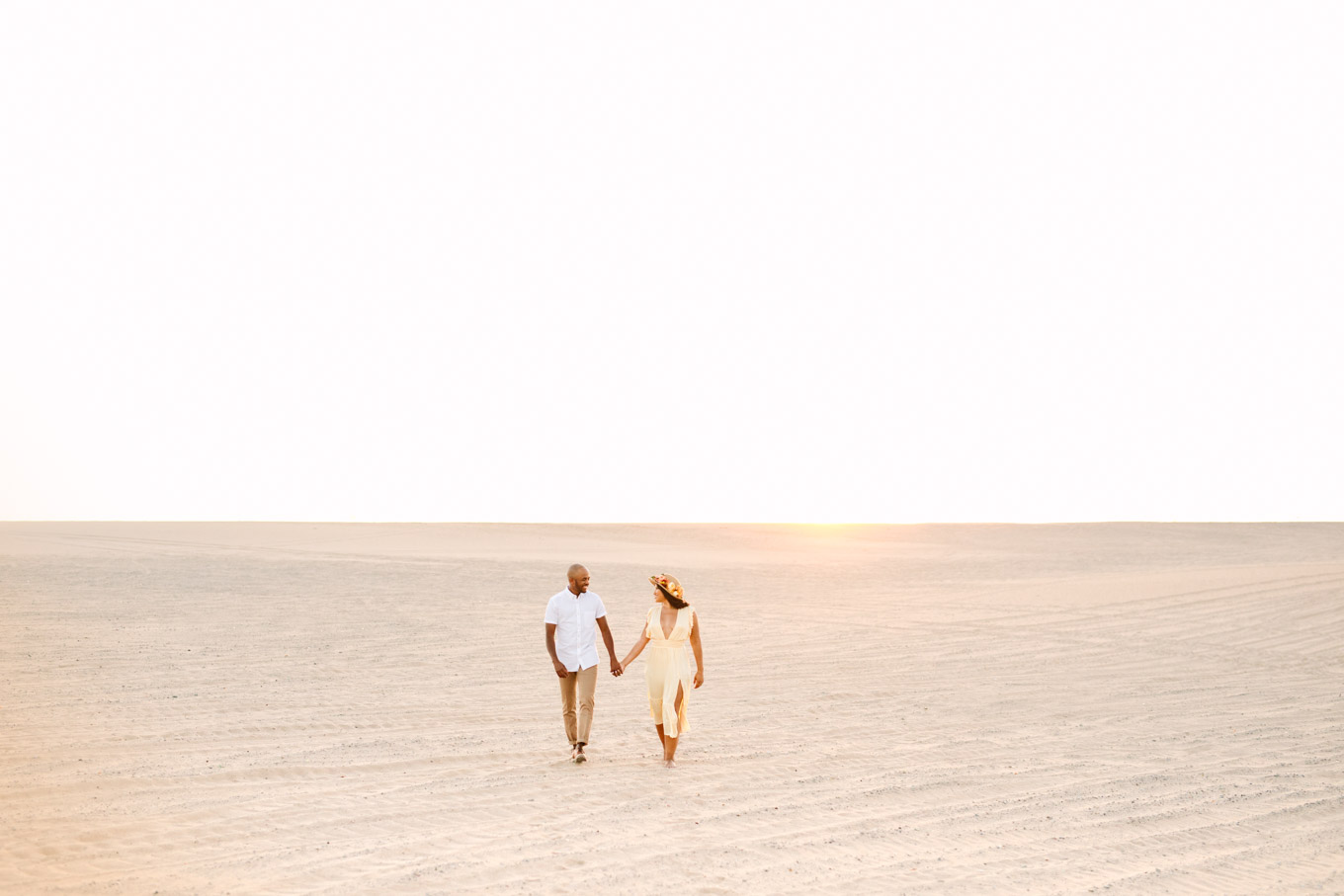 Engaged couple walking along a sand dune at sunset | California Sand Dunes engagement session | Colorful Palm Springs wedding photography | #palmspringsphotographer #sanddunes #engagementsession #southerncalifornia  Source: Mary Costa Photography | Los Angeles