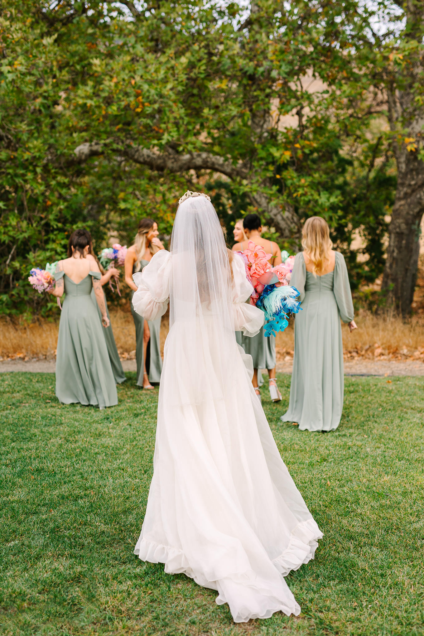 Bridesmaids in sage green gowns with colorful bouquets | Colorful and quirky wedding at Higuera Ranch in San Luis Obispo | #sanluisobispowedding #californiawedding #higueraranch #madonnainn   
Source: Mary Costa Photography | Los Angeles