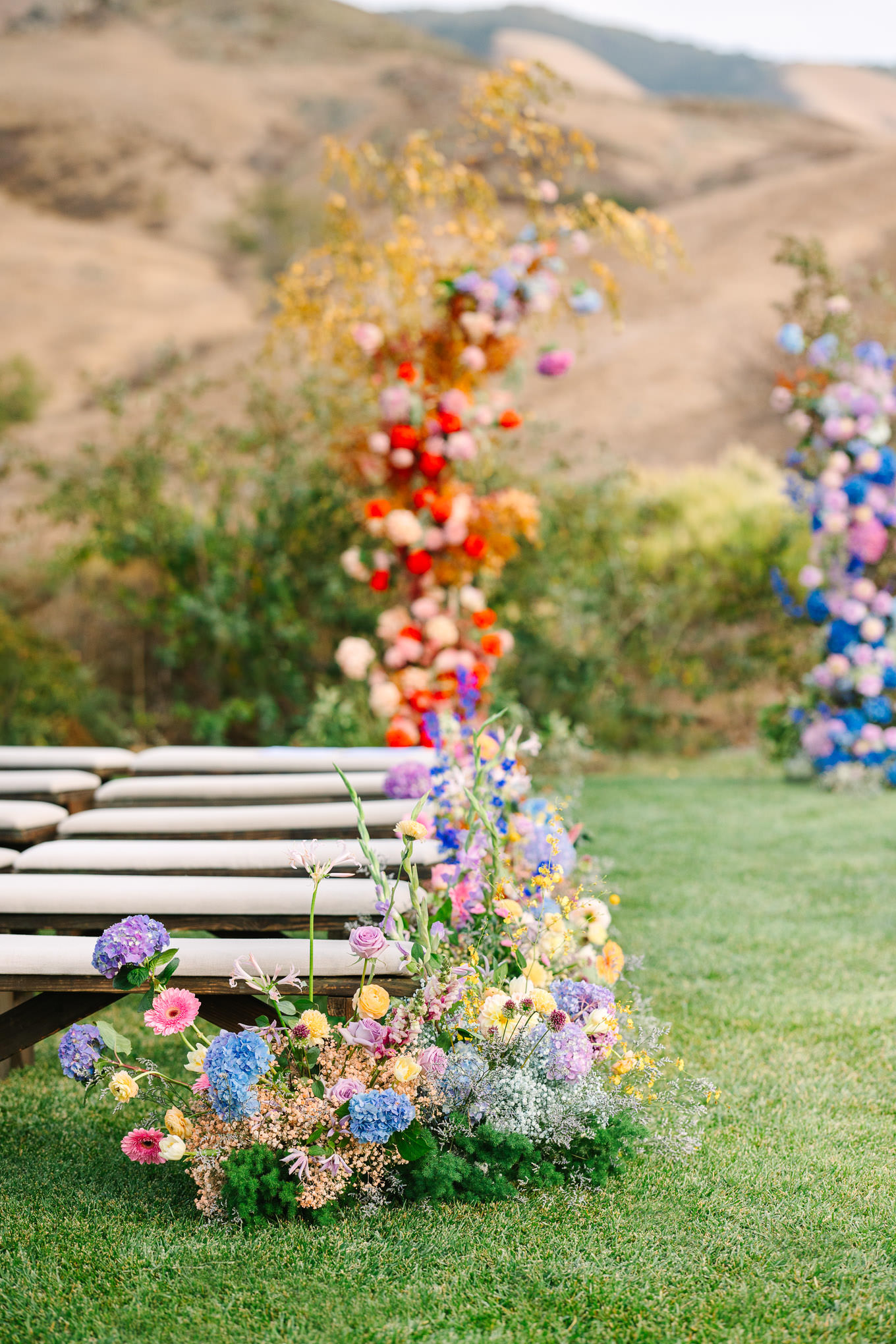 Whimsical and colorful floral installation at wedding ceremony | Colorful and quirky wedding at Higuera Ranch in San Luis Obispo | #sanluisobispowedding #californiawedding #higueraranch #madonnainn   
Source: Mary Costa Photography | Los Angeles
