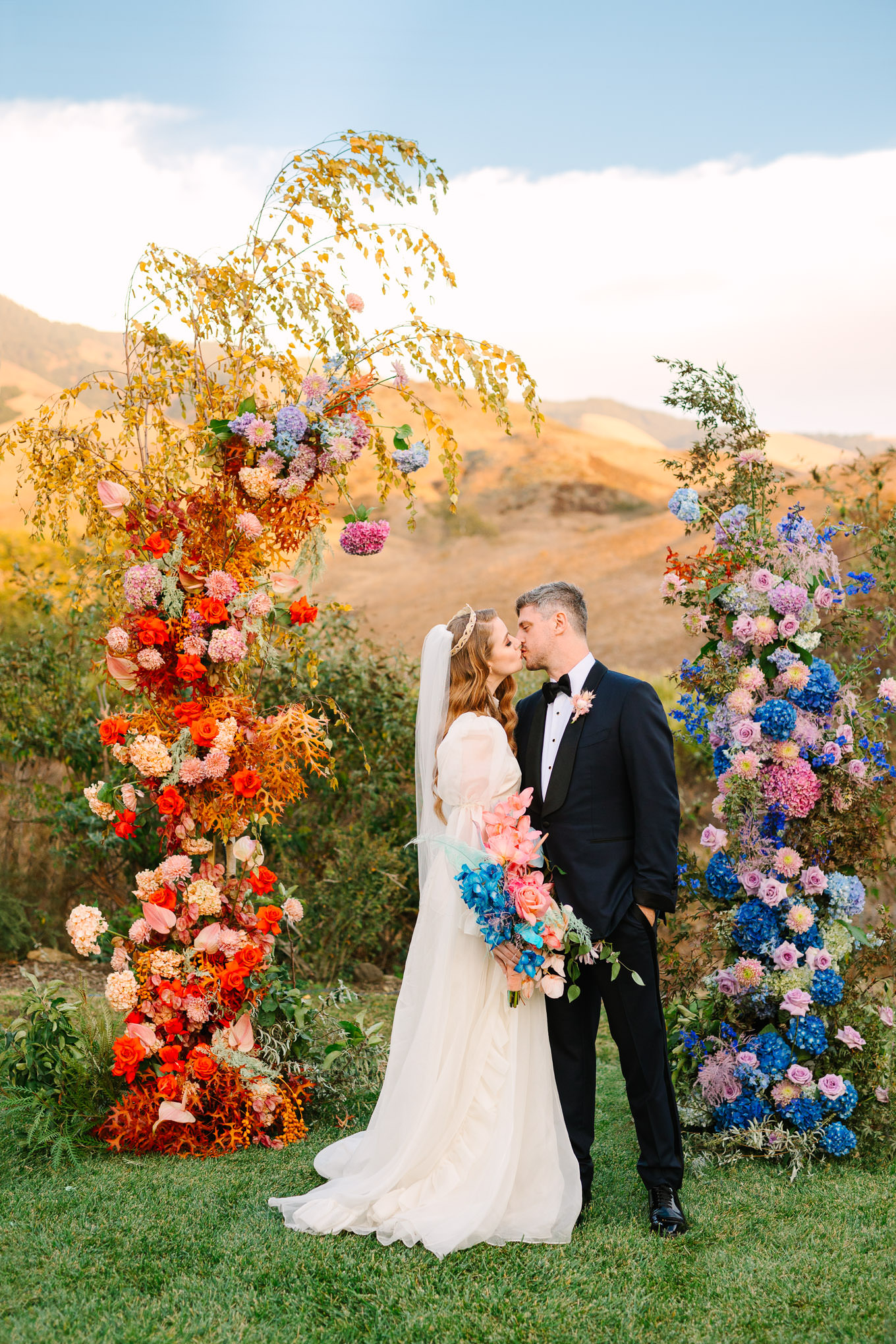 Allison Harvard & Jeremy Burke portraits at floral wedding ceremony installation | Colorful and quirky wedding at Higuera Ranch in San Luis Obispo | #sanluisobispowedding #californiawedding #higueraranch #madonnainn   Source: Mary Costa Photography | Los Angeles
