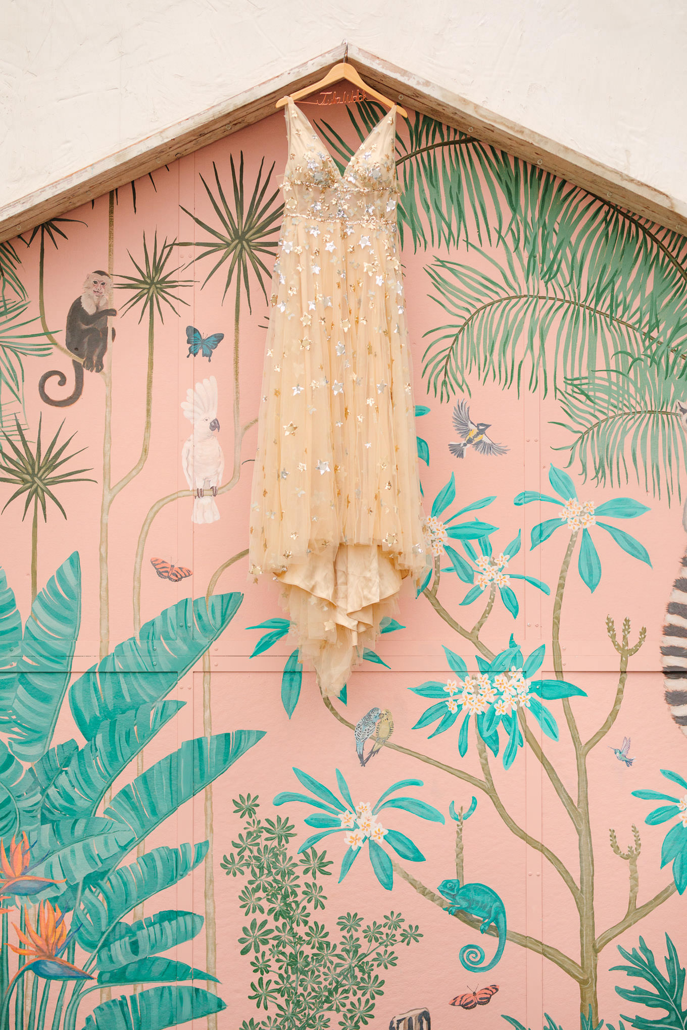 Orion Willowby by Watters dress hanging on Valentine mural | Colorful Downtown Los Angeles Valentine Wedding | Los Angeles wedding photographer | #losangeleswedding #colorfulwedding #DTLA #valentinedtla   Source: Mary Costa Photography | Los Angeles